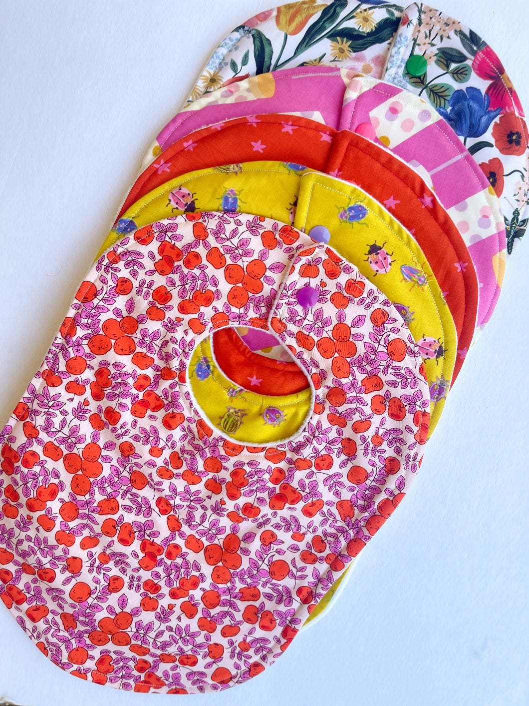 Five Mystery Baby Bibs